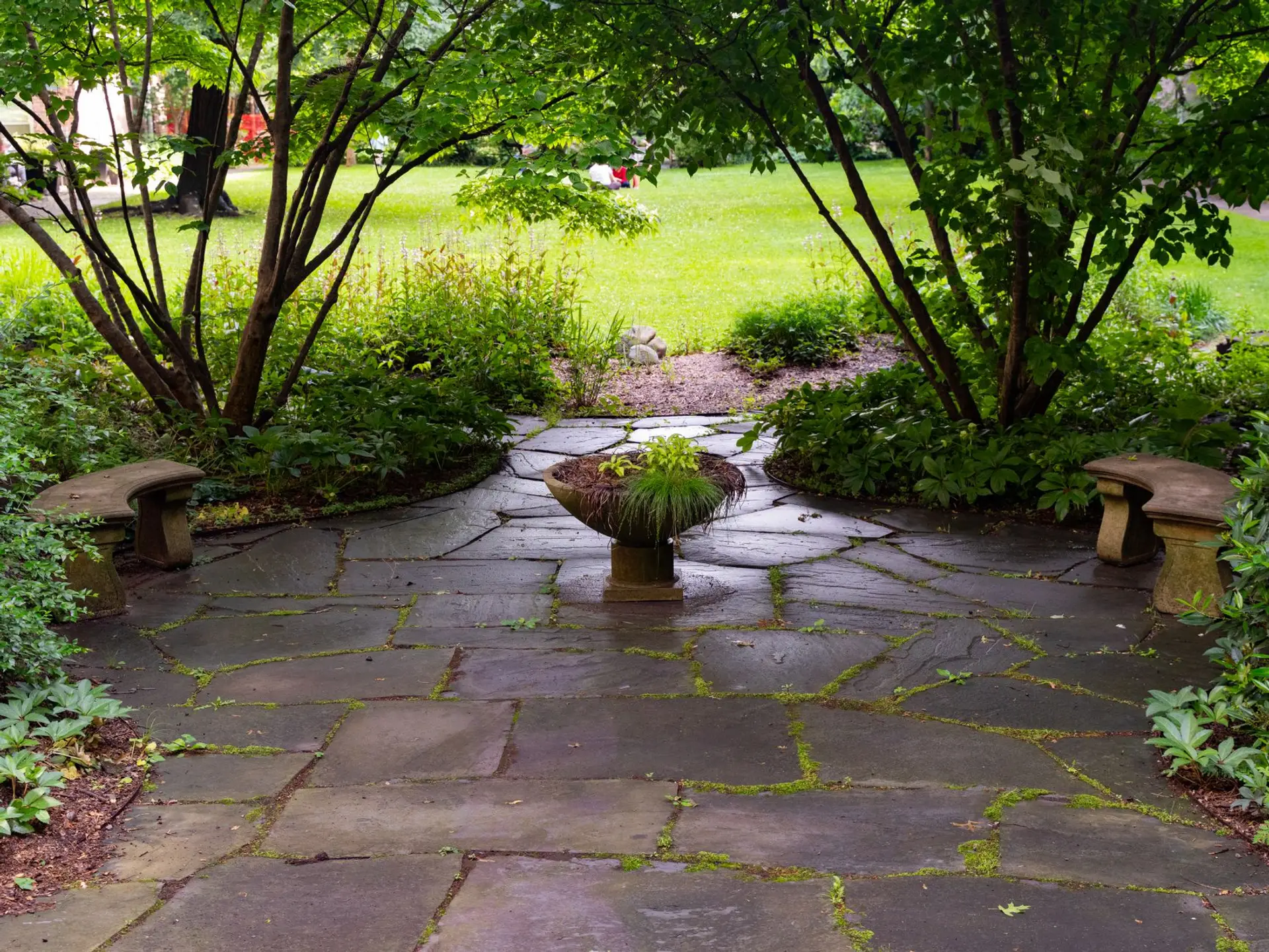 Newly installed paver patio with a stone fire pit and seating wall in a North Alabama backyard near Huntsville